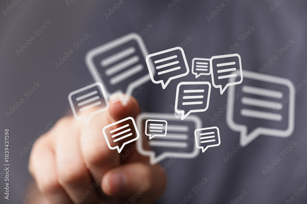 Fototapeta premium Hand interacting with virtual speech bubbles, representing communication, messages, and social media. Ideal for technology, connectivity concept