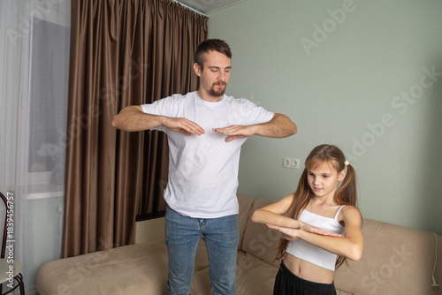 father and daughter are training at home. Workout in the apartment. Sports at home.