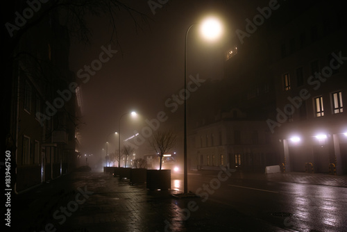 Street lights in mist. Autumn night with rain in the city