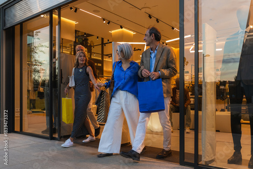 Group of mature friends enjoying a shopping day, exiting a retail store with purchases