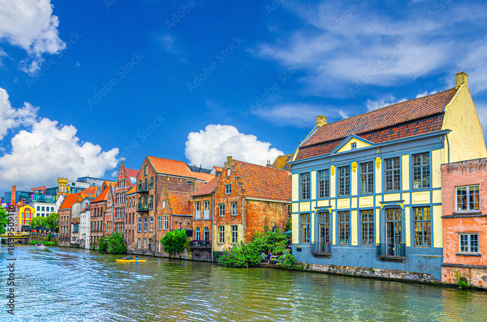 Fototapeta premium Row of old buildings houses on bank of Lys Leie river in Patershol quarter district in Ghent historical city centre, Gent old town, East Flanders province, Flemish Region, Belgium