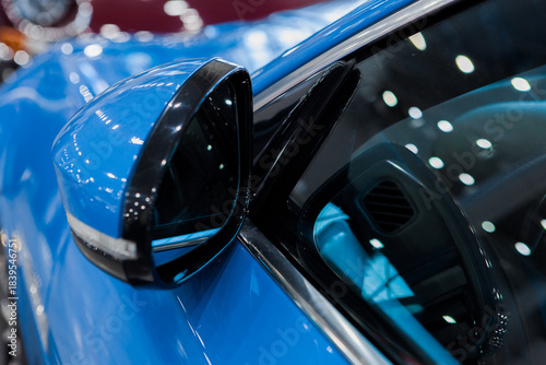 close-up of the side mirror of a blue car
