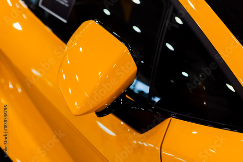 close-up of the side mirror of a yellow car