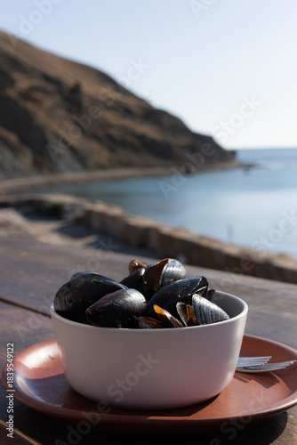 Detailed Capture Of Succulent Mussels Garnished With Herbs Against Rustic Wooden Surface With Morning Light