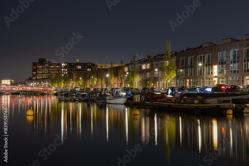 Colorful night view reflected on canal Amsterdam