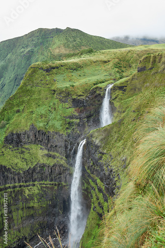 Konstfotografi Tall twin waterfalls in dramatic rainforest canyon, Flores Island, Azores