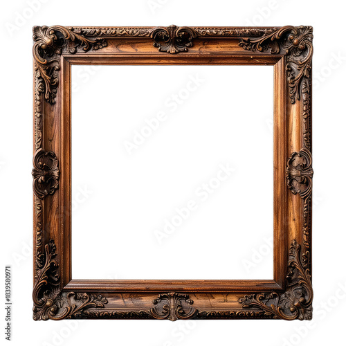 An ornate, antique wooden picture frame with intricate carvings displayed against a solid black background.