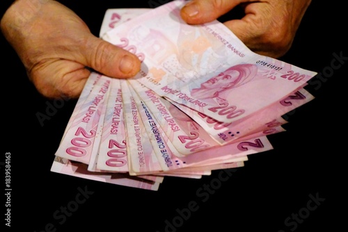 Close-up of 200 Turkish Lira banknotes in an elderly woman's hands. Pension. Old-age pension. Pensions. Inflation. Year-end salary increases for civil servants and retirees. 200 TL.