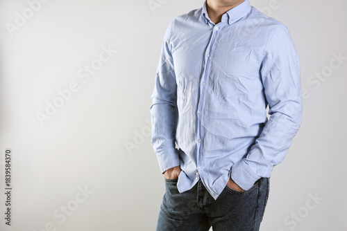 Fényképezés Man in creased shirt near grey wall, closeup. Space for text