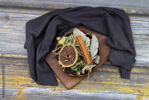 Winter tea for health in cold weather. Flavored with ginger, cinnamon, hibiscus, and orange. Isolated on woodenn background