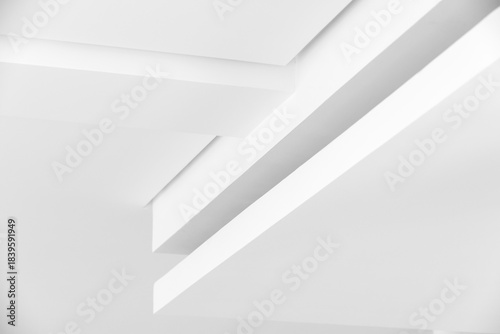 Abstract photo featuring white planes, layered edges, and floating forms