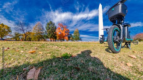 Electric bike parked on grass near the Washington Monument in fall