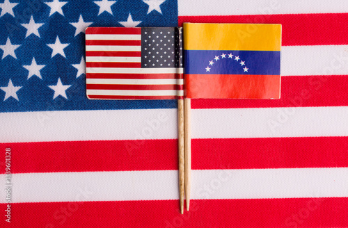 flags of the USA and Venezuela on the background of the flag of the USA