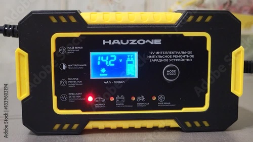 The intelligent pulse repair charger works at home and charges the battery.
