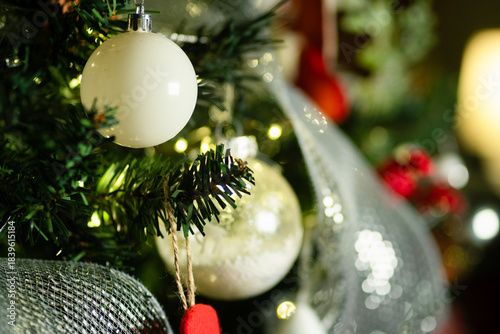 Christmas tree decorations hanging on pine branch