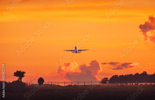 Jet Airliner Ascending into Fiery Sunset Sky
