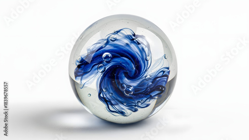 Clear glass paperweight with internal blue swirl design isolated on white background, spiral, art object, creative, transparent