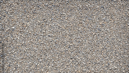 texture of small grey gravel stones or pebbles covering the ground