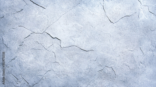 A textured, light blue wall with visible cracks and imperfections, creating an artistic and abstract appearance.