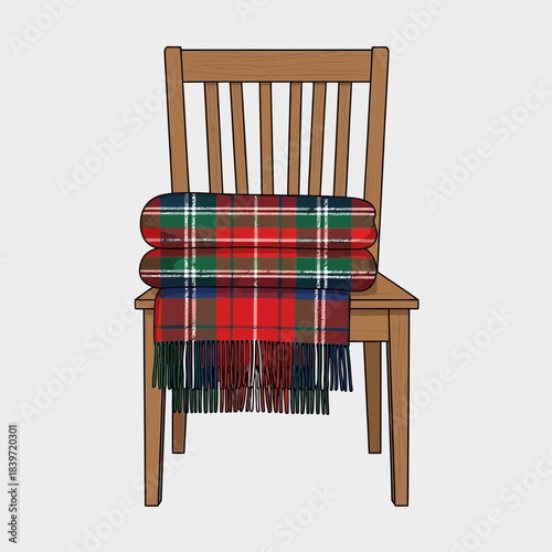 Cozy wooden chair with colorful plaid blanket draped over the backrest for comfort and warmth