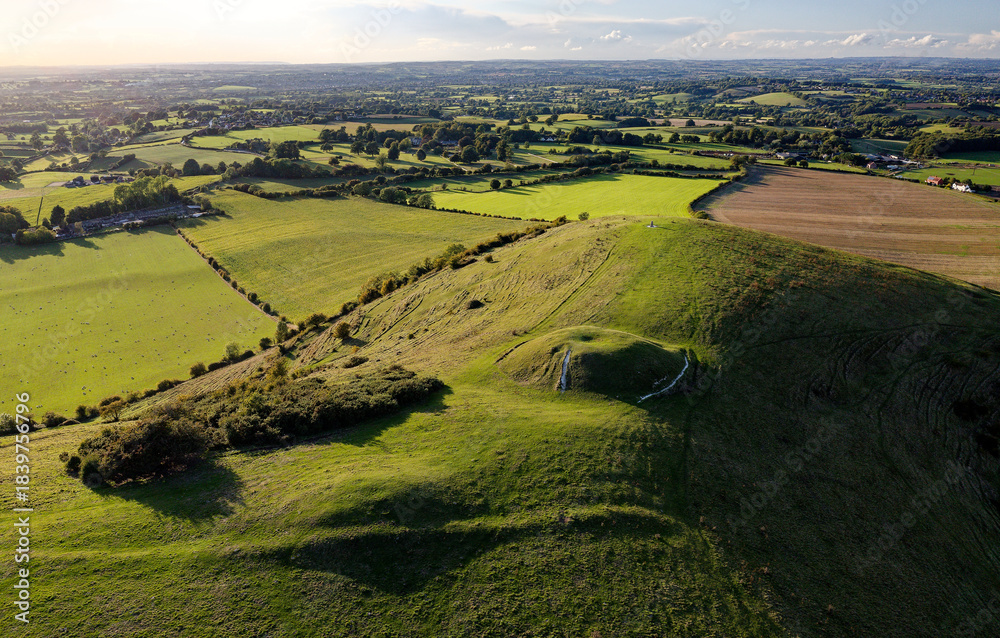 Obraz premium Cley Hill Camp univallate Iron Age hillfort near Warminster, Wiltshire. The 2 central Bronze Age bowl barrows seen from the south east
