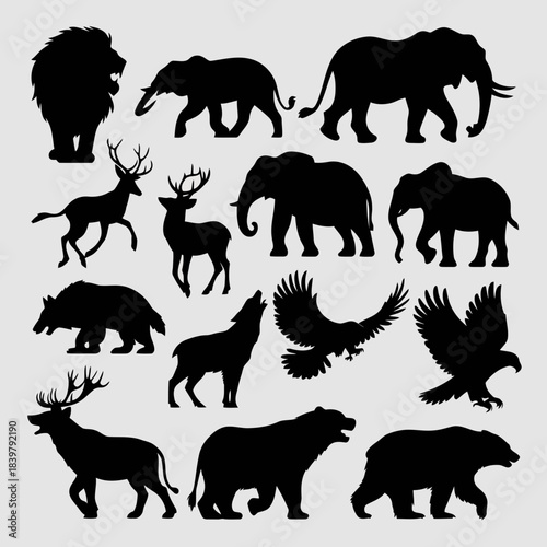 Collection of black silhouettes of various wild animals including lions, elephants, bears, and birds isolated on