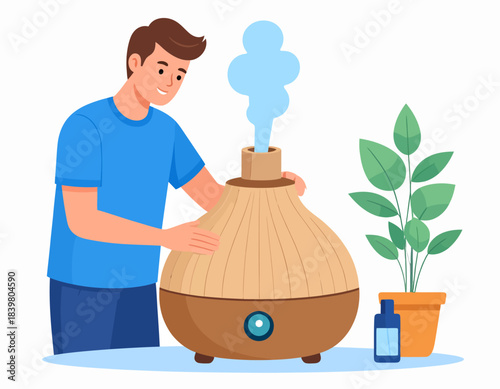 A man setting up an essential oil diffuser with mist rising, next to a plant and oil bottle.