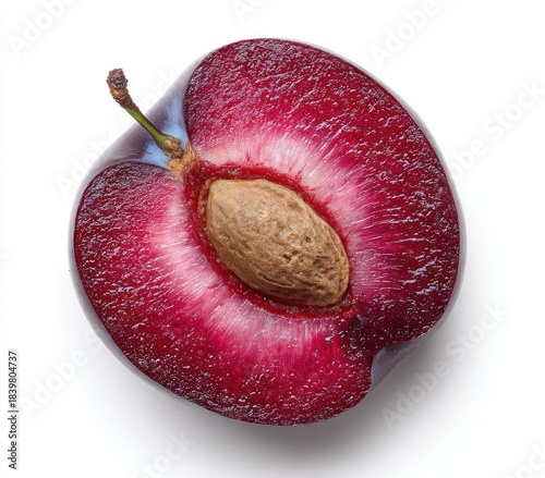 Cross-section of a halved, ripe fruit revealing a single pit against a white background