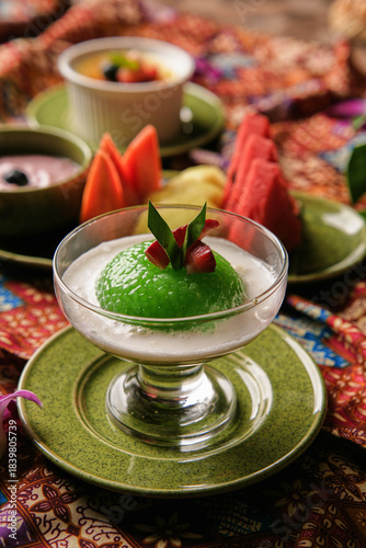 Traditional Sago Gula Melaka dessert with pandan sago pearls and creamy coconut milk, served in an elegant glass with tropical styling and vibrant cultural background.
