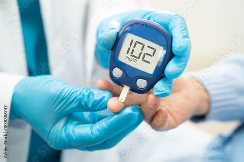 Doctor check diabetes from finger blood sugar level with finger lancet.