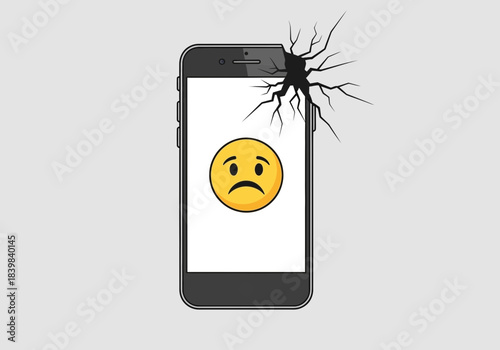 Smartphone with cracked screen displaying a sad emoji.