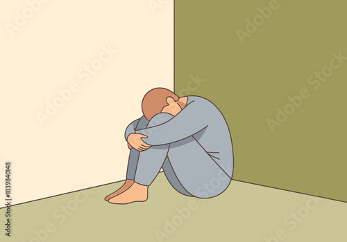 Person curled up in a corner, appearing distressed or contemplative.