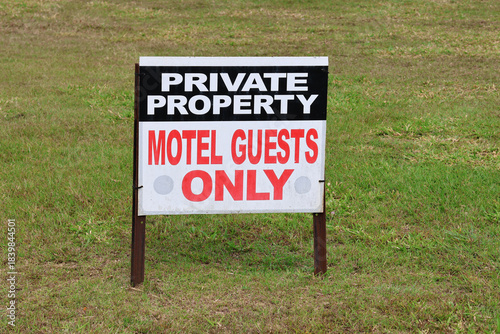 Private Property - Motel Guests Only sign placed on grass