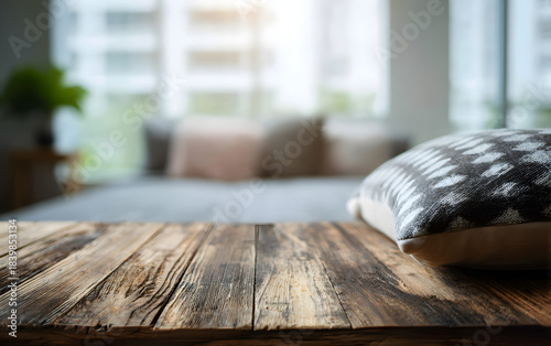 Cozy Bedroom Scene Featuring a Wooden Table Top in Focus with a Soft, Blurred Pillow on the Bed in the Background, empty wooden table