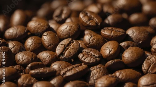 Close-up of roasted coffee beans, various shapes and textures, warm brown color