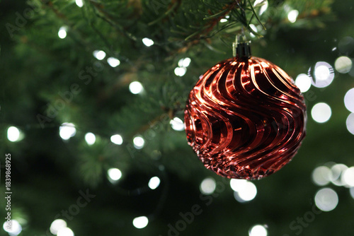 A red glass Christmas ball hanging.