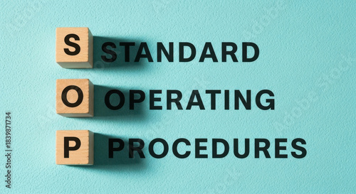 Wooden blocks spelling out Standard Operating Procedures against a light blue background, showing operational workflow and compliance.