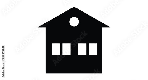 A simple black house icon with a circular window and rectangular openings a silhouette