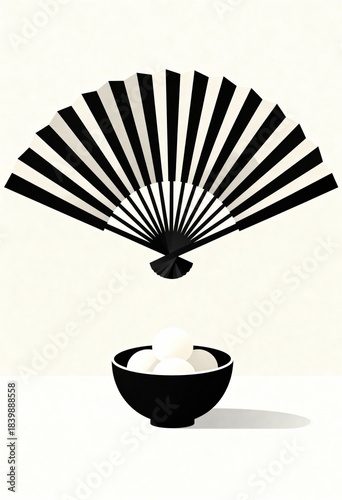 Japanese Folding Fan Floating Over Bowl of Mochi