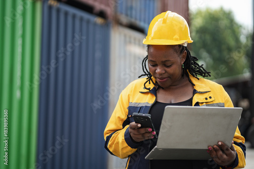 Portrait African woman logistics workers use notebook computer checking container	