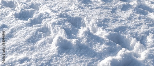 Close up view of freshly fallen crystalline snow surface with slight texture and minimal indentation showing pristine untouched nature for fresh start new beginning and winter purity renewal concept.