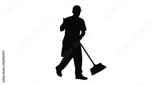 Silhouette of a cleaner or janitor sweeping with a broom