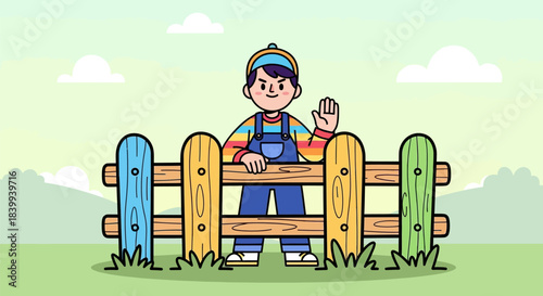 Young boy in colorful overalls and cap waving behind a wooden fence.