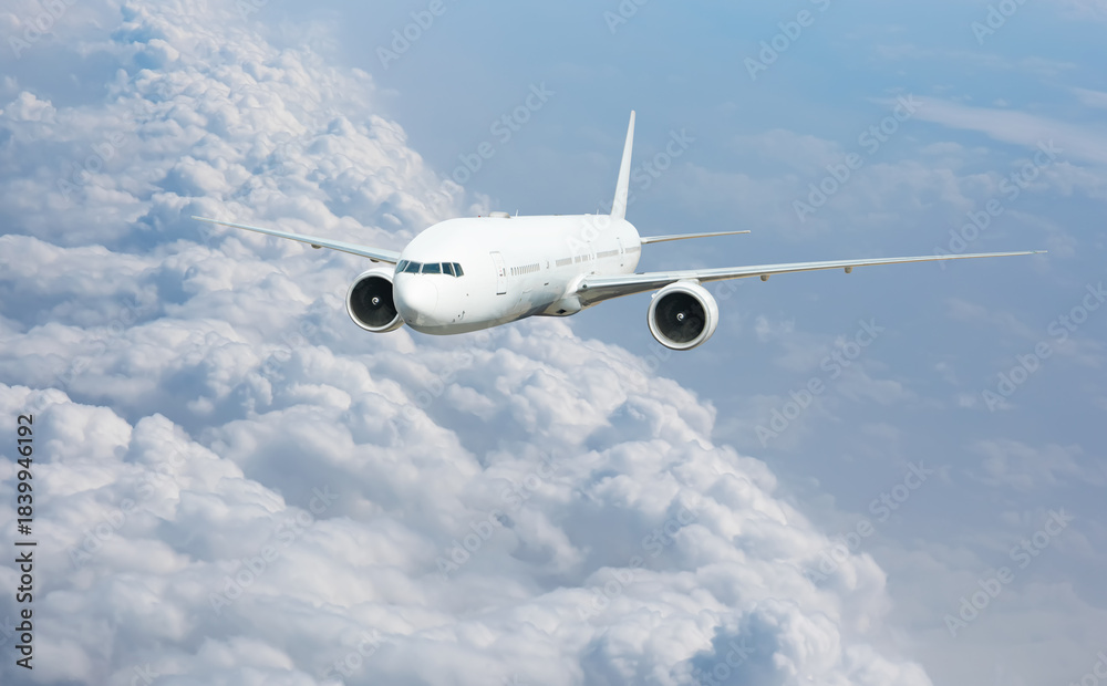 Obraz premium White passenger airplane flying in the sky amazing clouds in the background - Travel by air transport