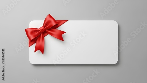 Blank white gift card with a vibrant red satin ribbon and bow, perfect for any special occasion