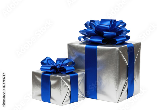 three luxury gift boxes wrapped in reflective metallic silver foil, secured with oversized sapphire blue satin bows, isolated on a white studio background with copy space. Concept for high-end