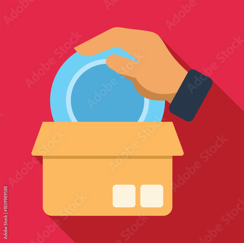 Hand dropping a blue coin into a cardboard donation box for charity