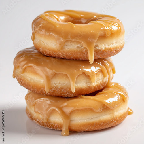 Miso caramel donuts stacked pyramid-style, glaze dripping slightly on one side only