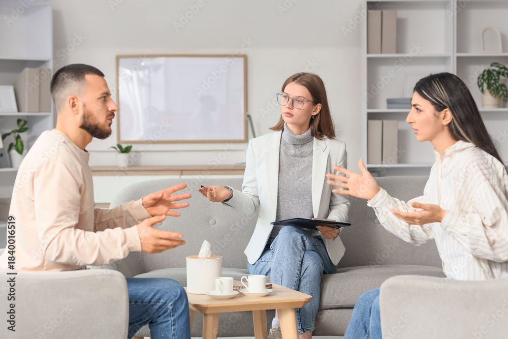 Fototapeta premium Family mediator talking with couple in office