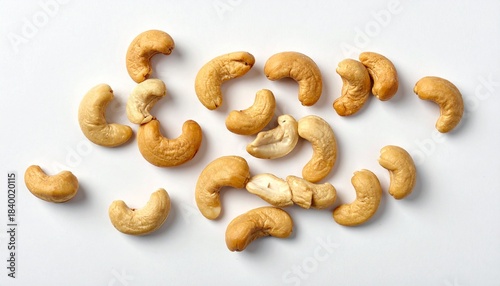 “Roasted cashew nuts scattered on a white surface.”